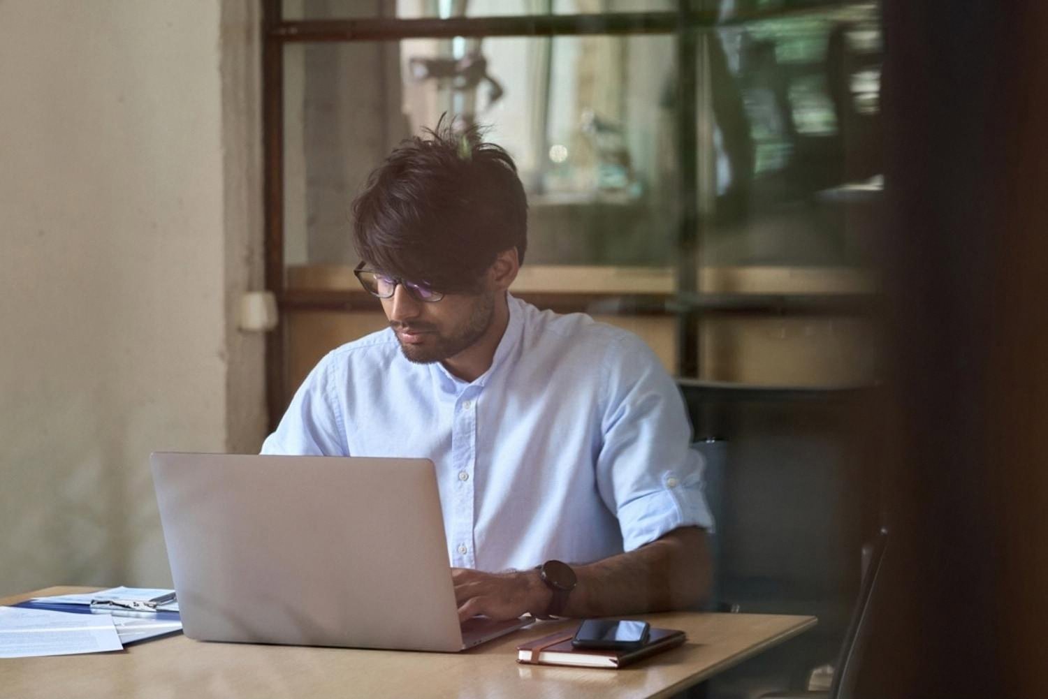 Young man studying on a laptop, representing CBSE self-study routines in the UAE